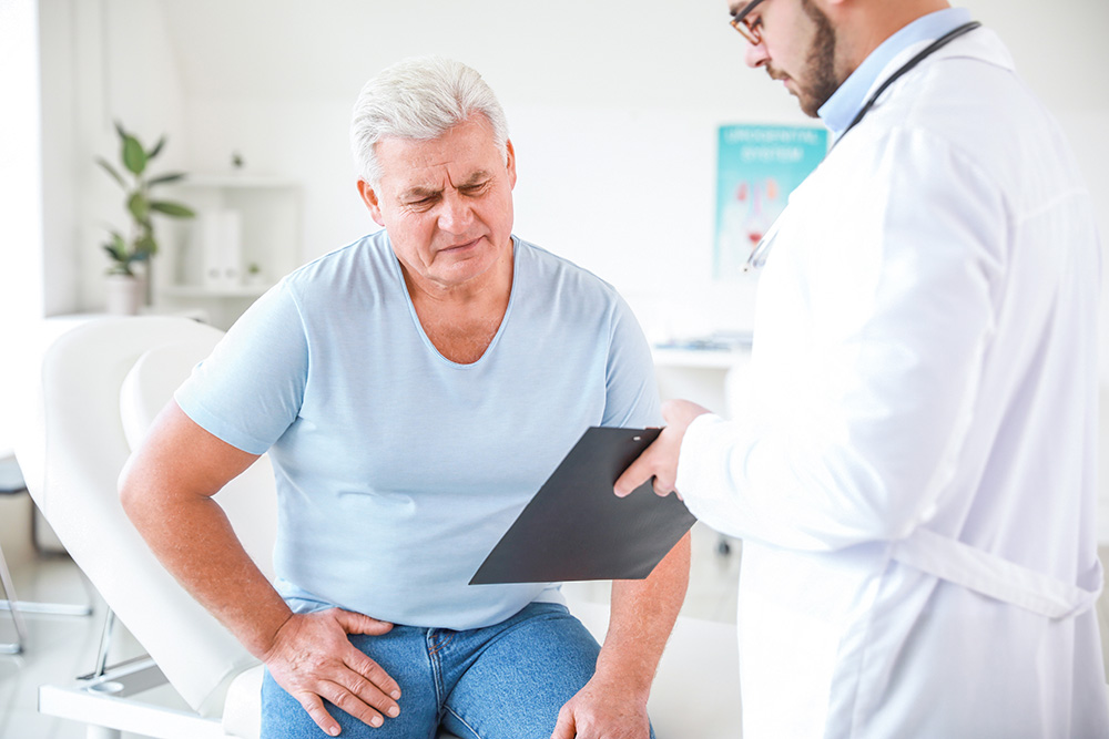 Senior male patient visits urologist for BPH and enlarged prostate.